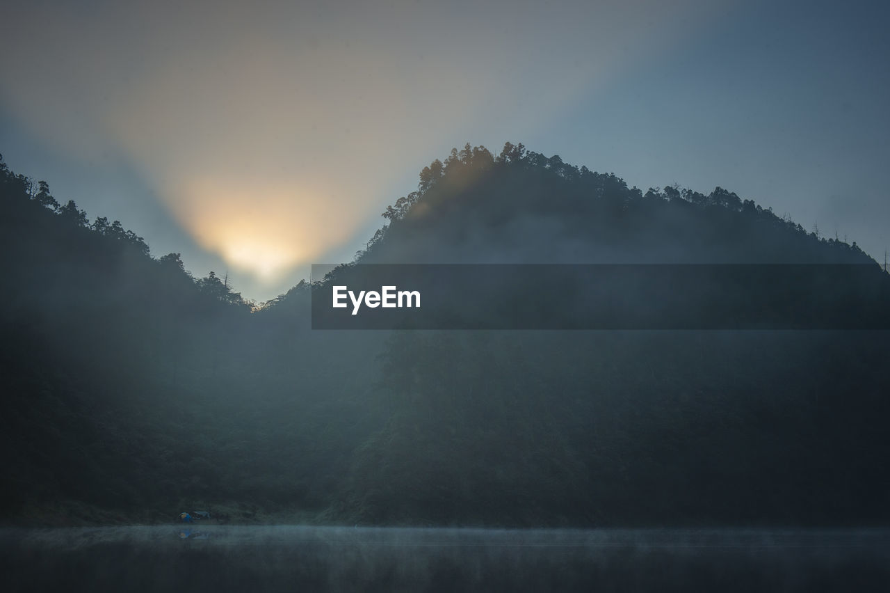 Scenic view of mountains against sky during sunset