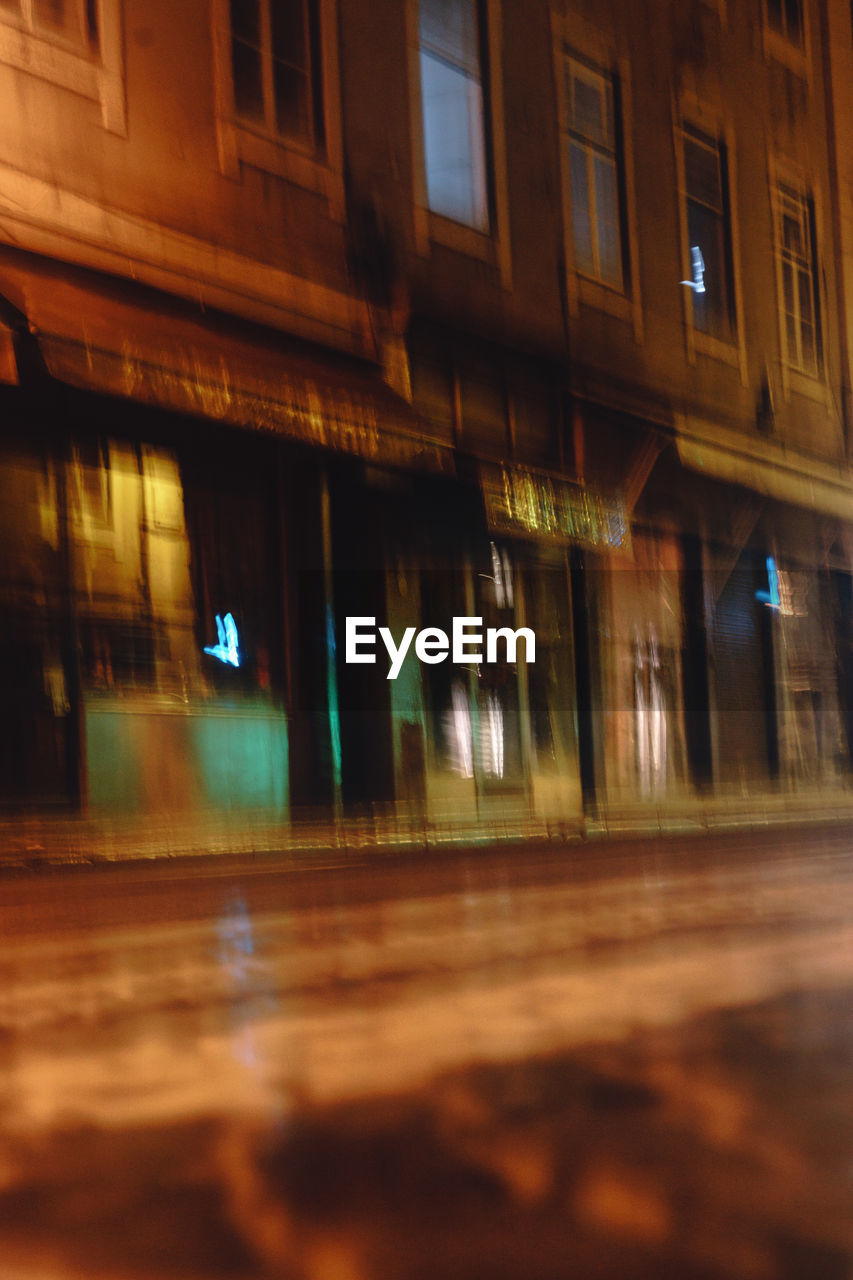 Defocused image of footpath against building in city