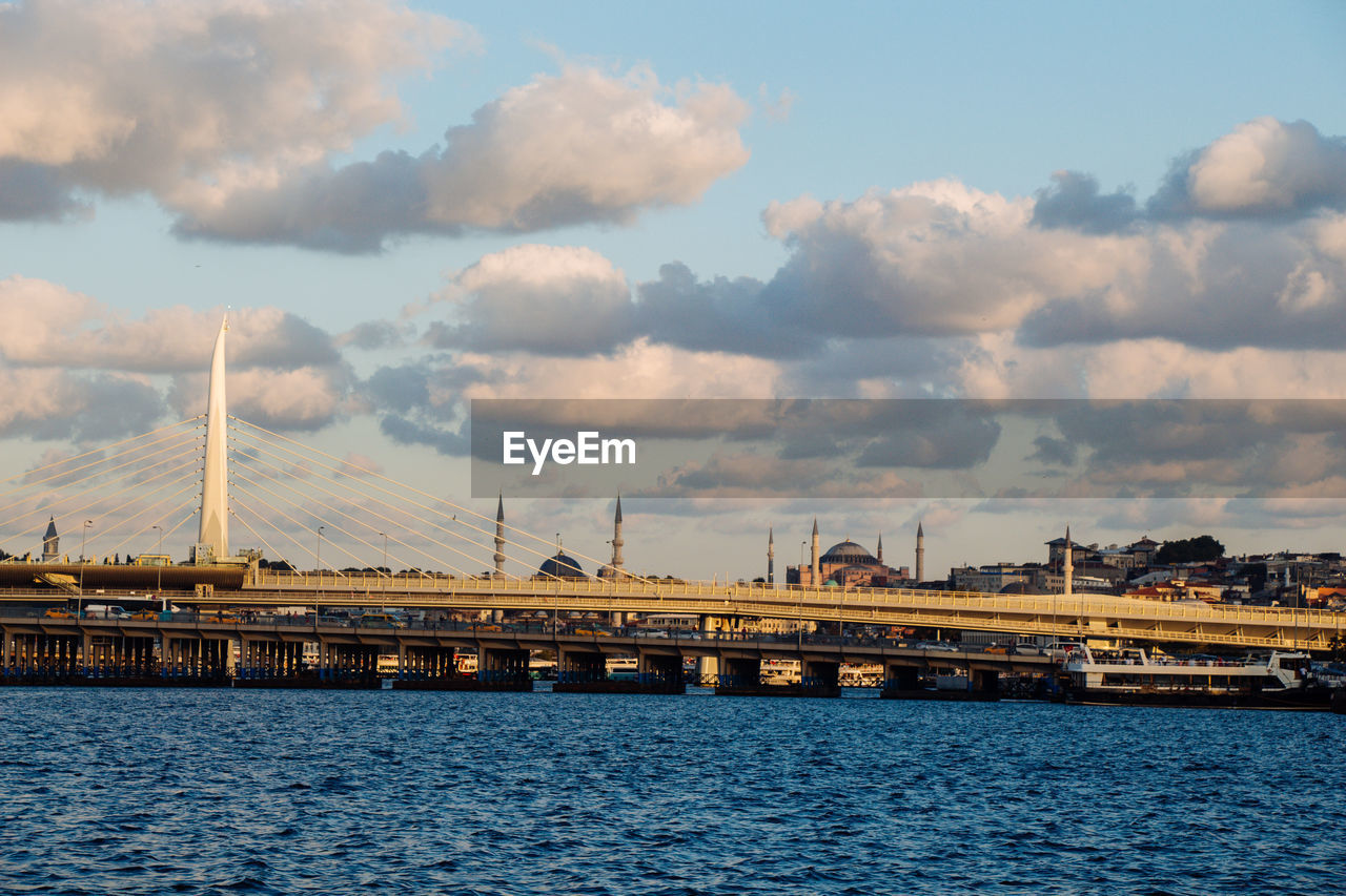 VIEW OF BRIDGE OVER RIVER AGAINST SKY IN CITY