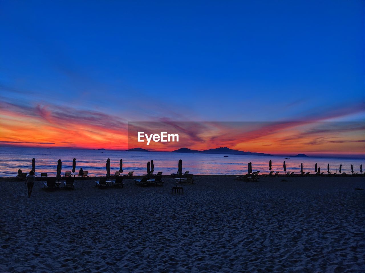 Scenic view of beach against sky during sunset