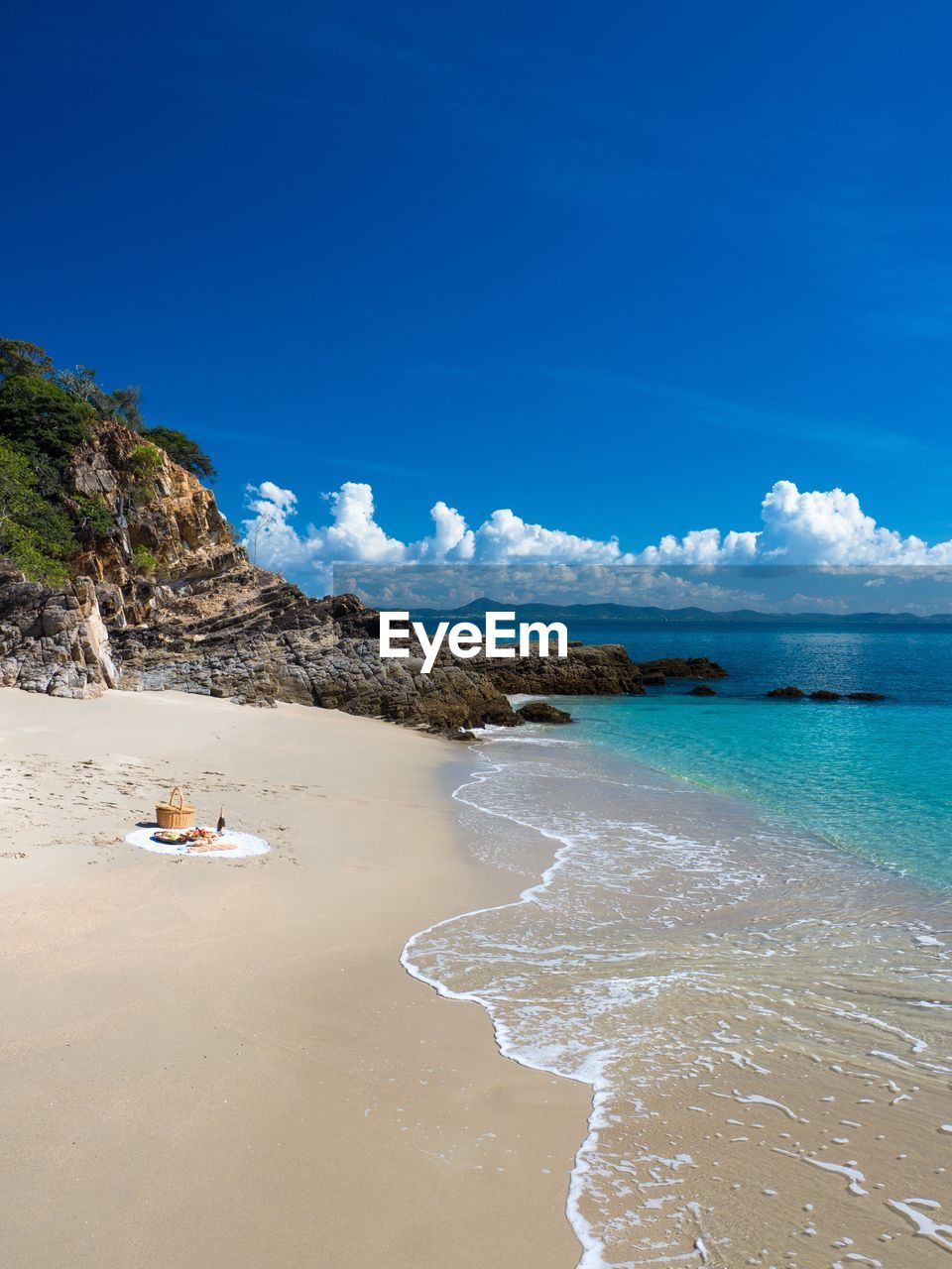 Scenic view of beach against blue sky