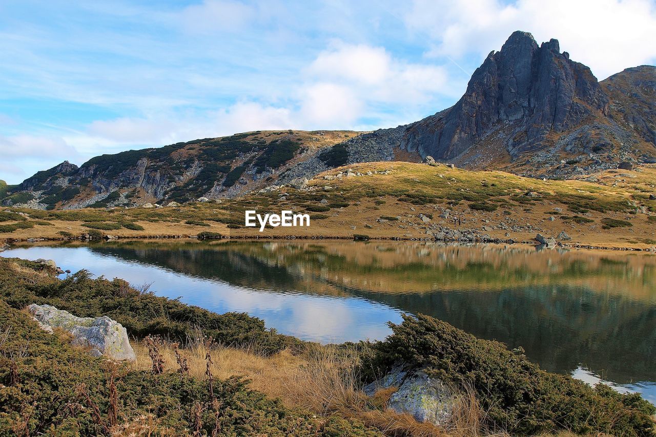 Scenic view of lake and mountains against sky