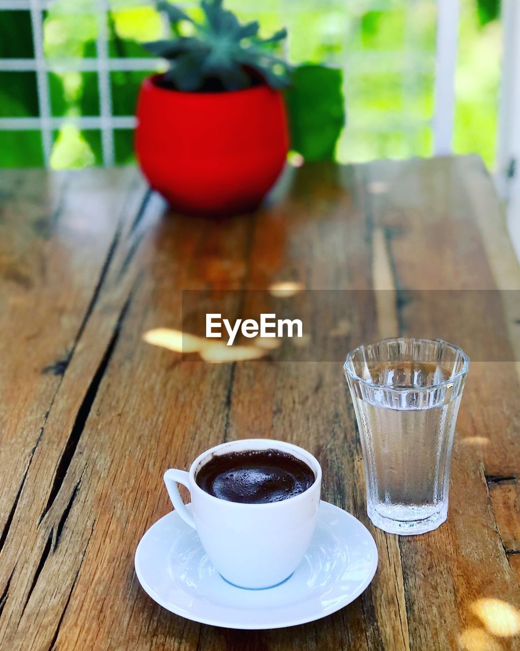 COFFEE CUP ON TABLE WITH GLASS