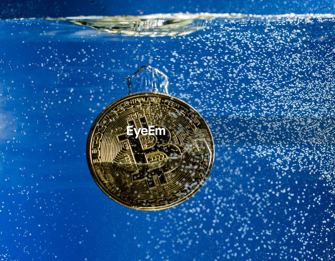 Close-up of bitcoin in water