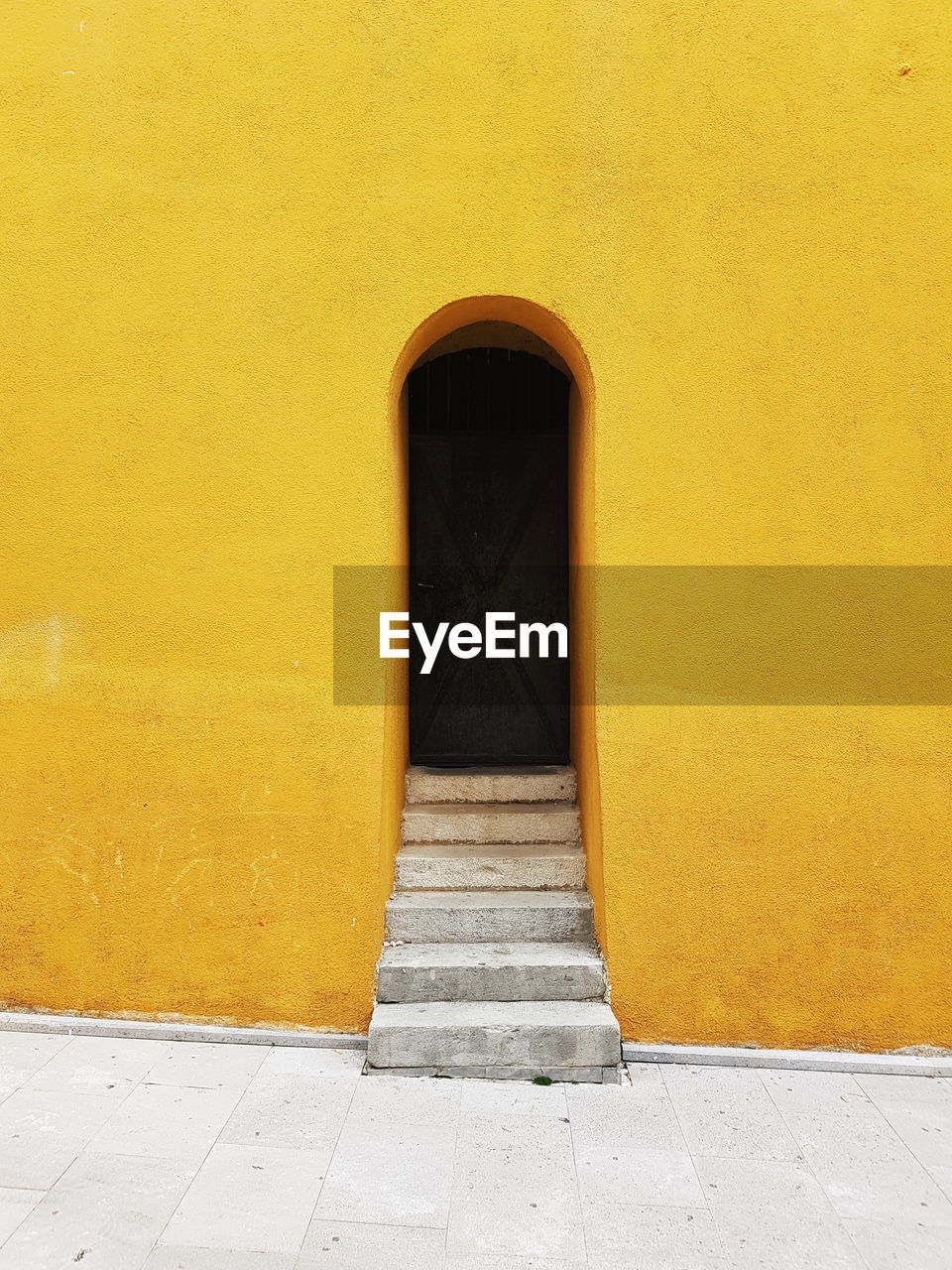 Minimalist doorway on a yellow building.