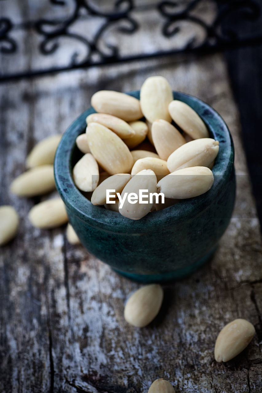 cropped hand of person holding food in bowl on table