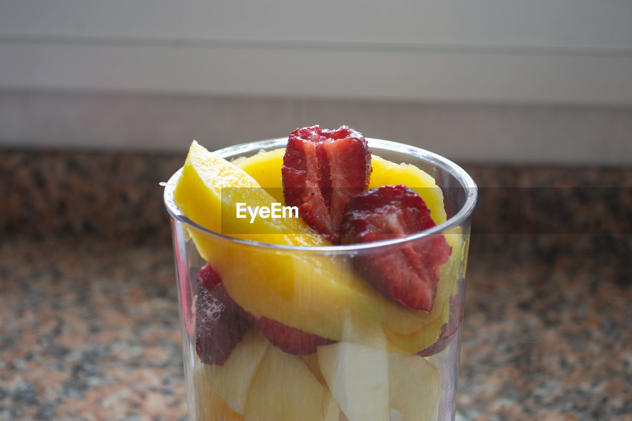 CLOSE-UP OF APPLE ON GLASS