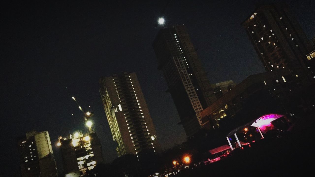 SKYSCRAPERS IN CITY AT NIGHT