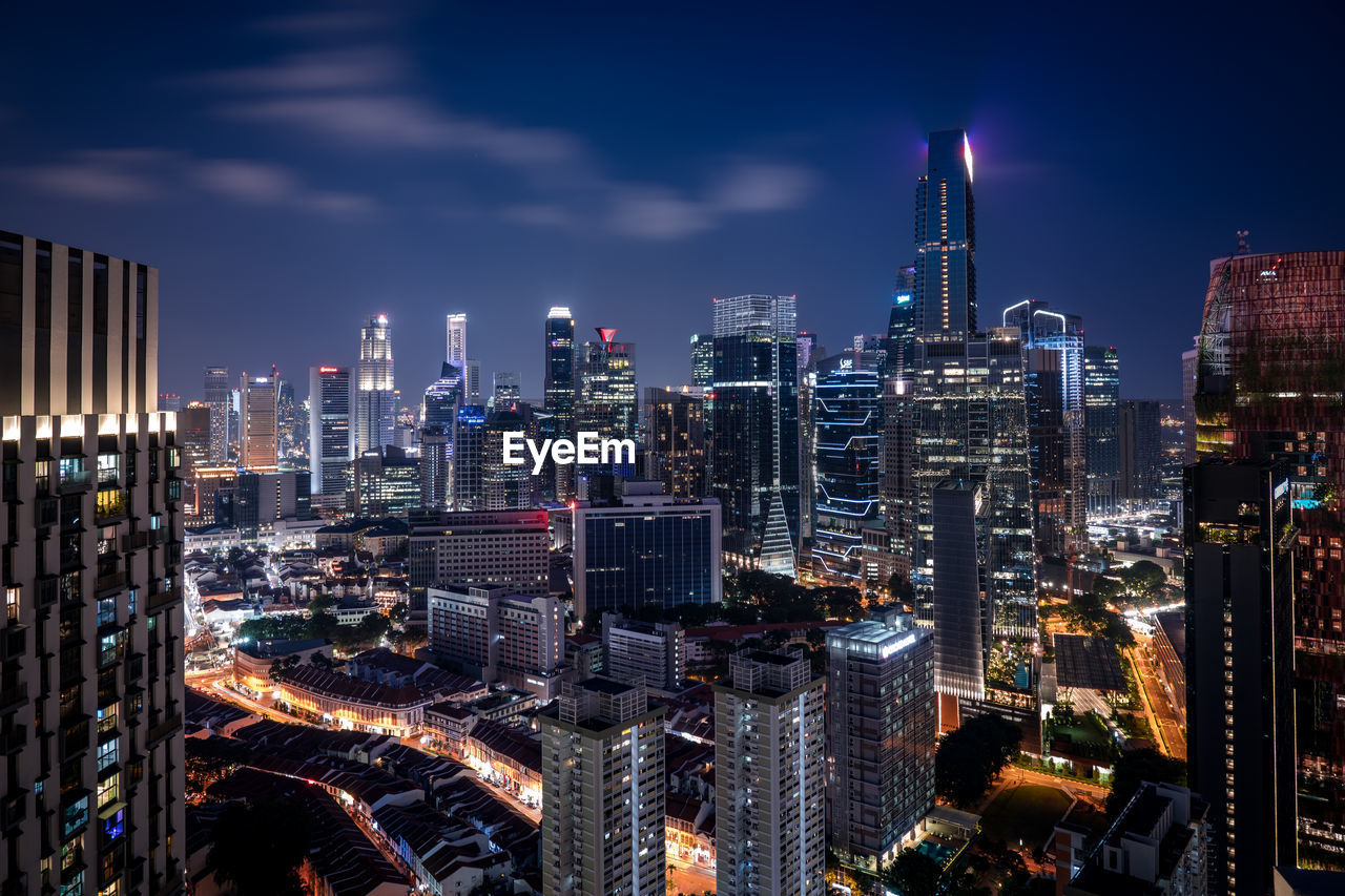 Illuminated cityscape against sky at night