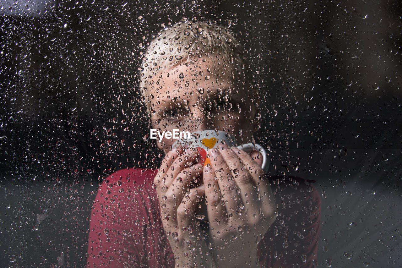 Woman seen through wet glass