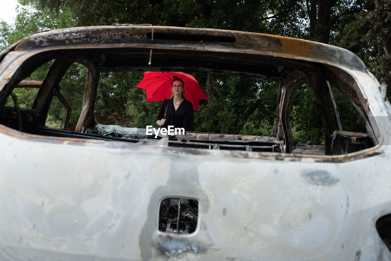 PEOPLE IN ABANDONED CAR BY WINDOW