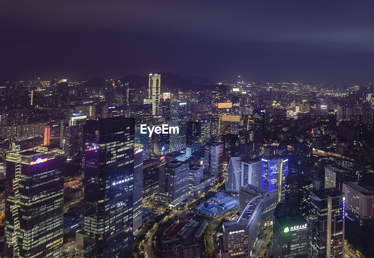 AERIAL VIEW OF ILLUMINATED CITY AT NIGHT