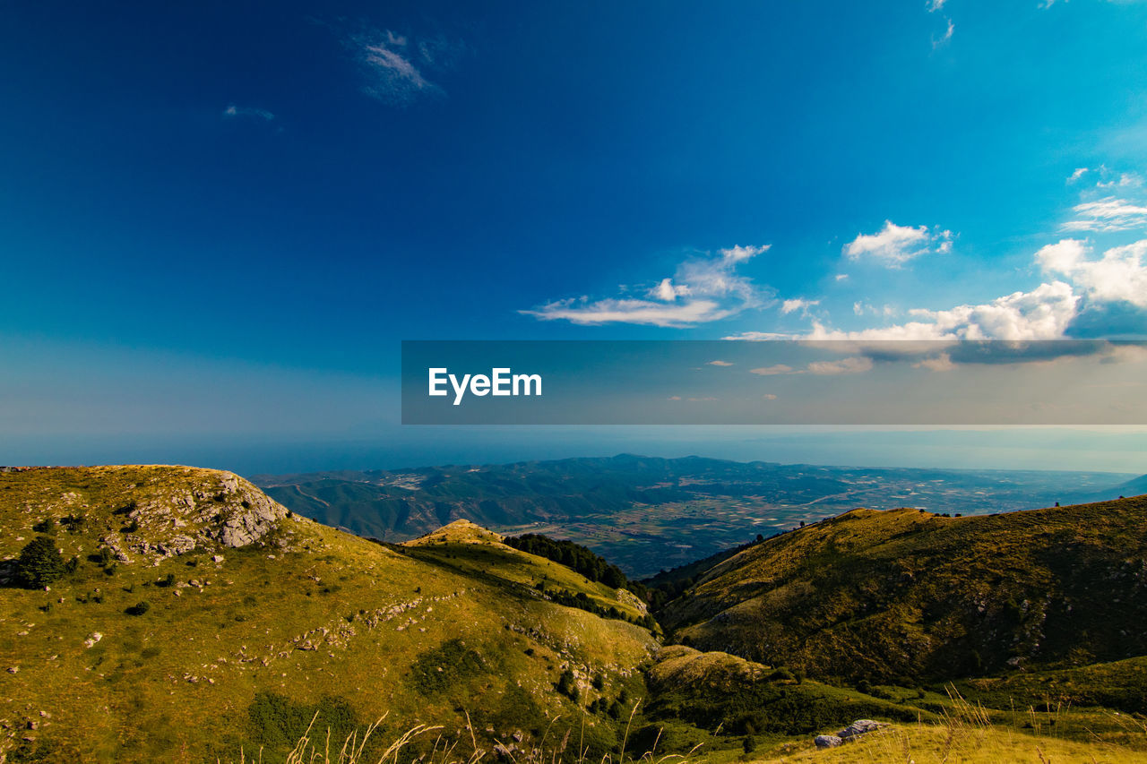 Scenic view of landscape against blue sky