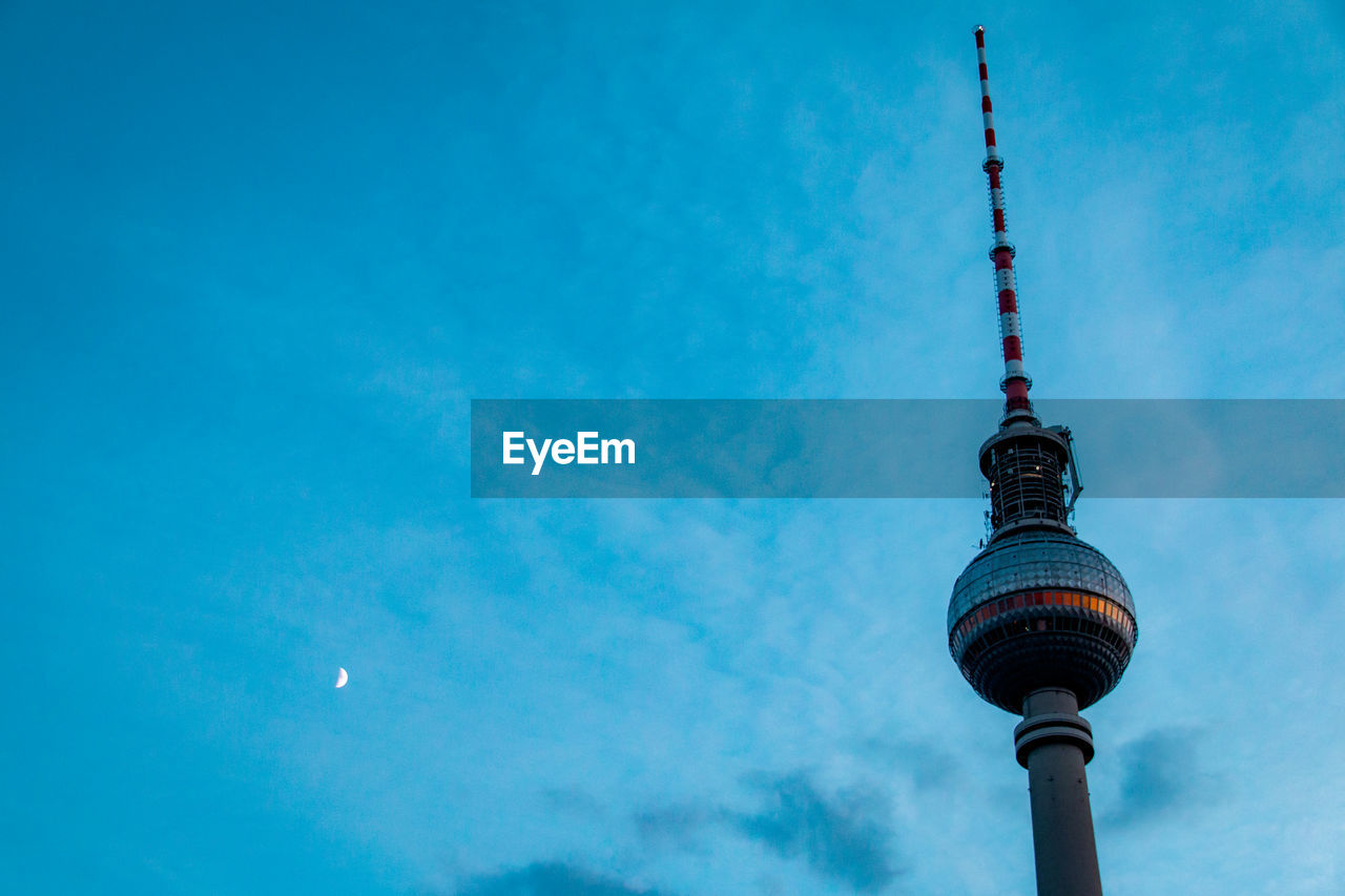 Low angle view of fernsehturm against sky at dusk