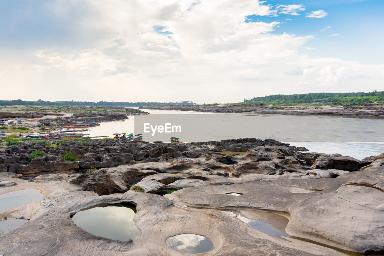 ROCKS ON BEACH AGAINST SKY