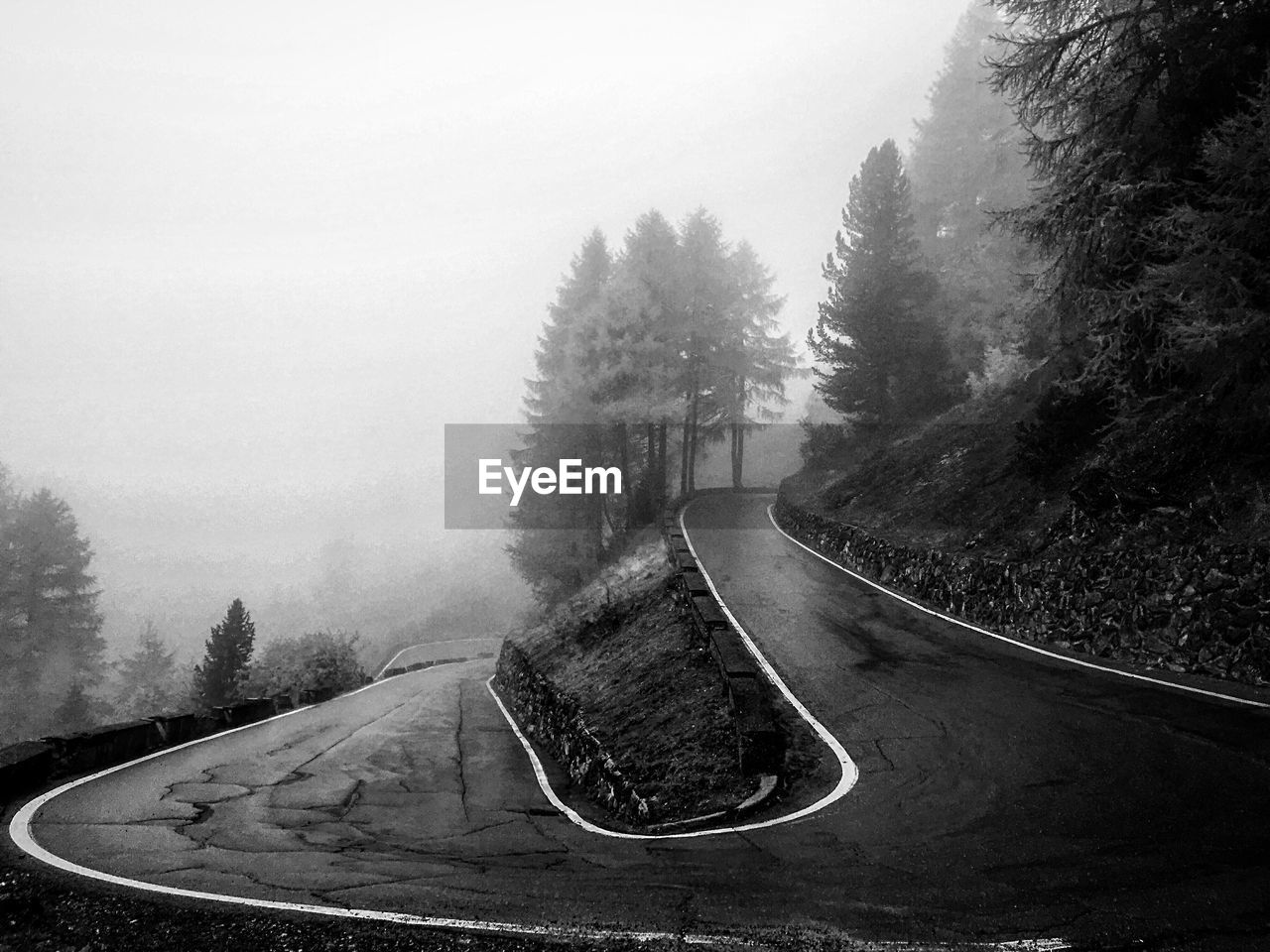 Winding mountain road in foggy weather