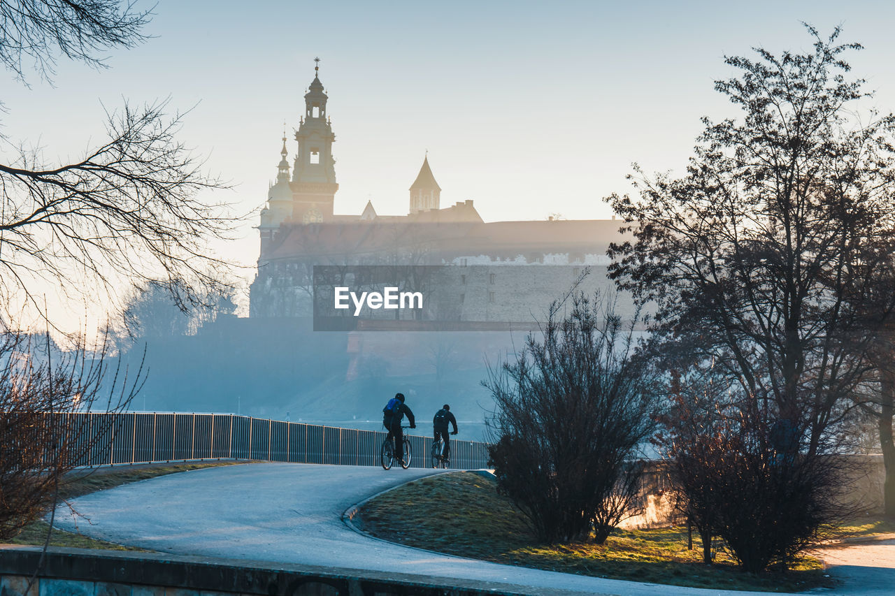 PEOPLE WALKING IN FRONT OF BUILDINGS