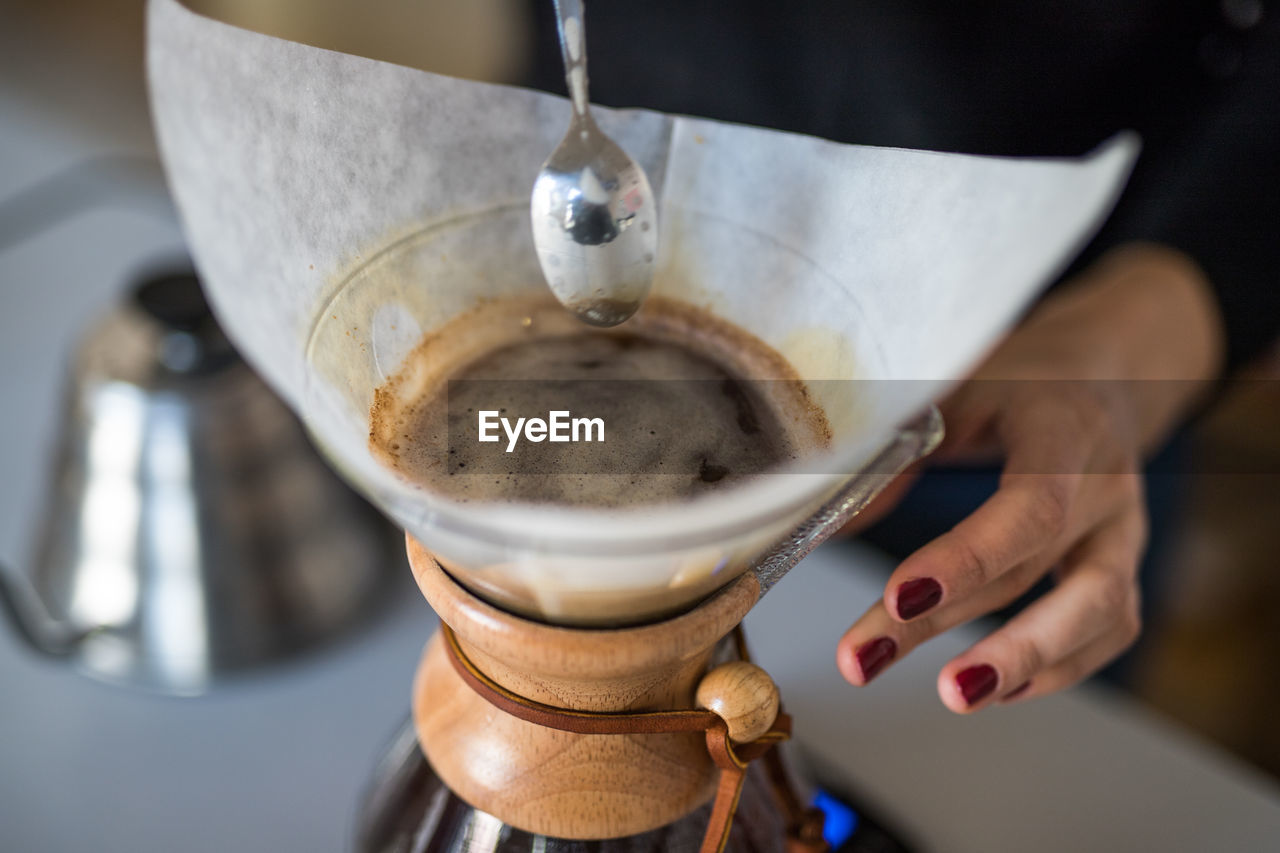 Close-up of hand preparing coffee