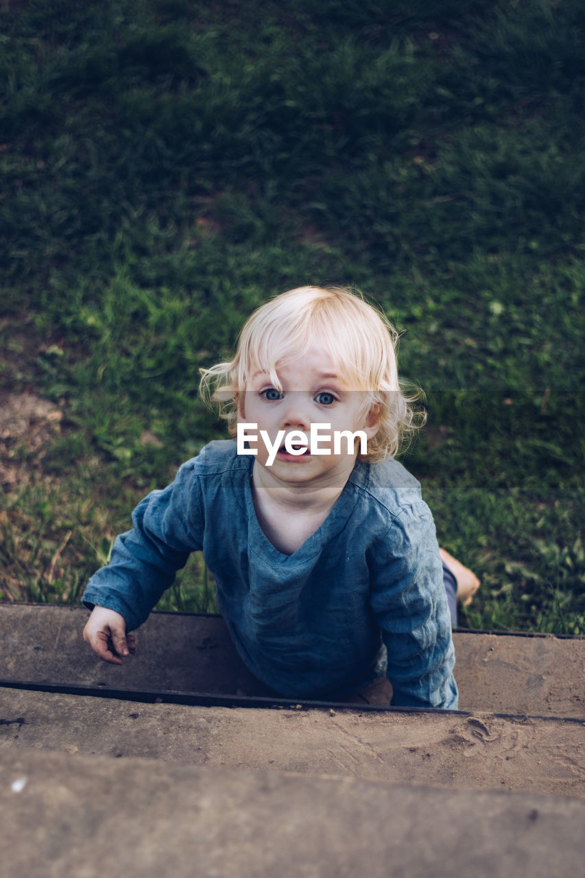 Portrait of cute baby girl leaning on steps