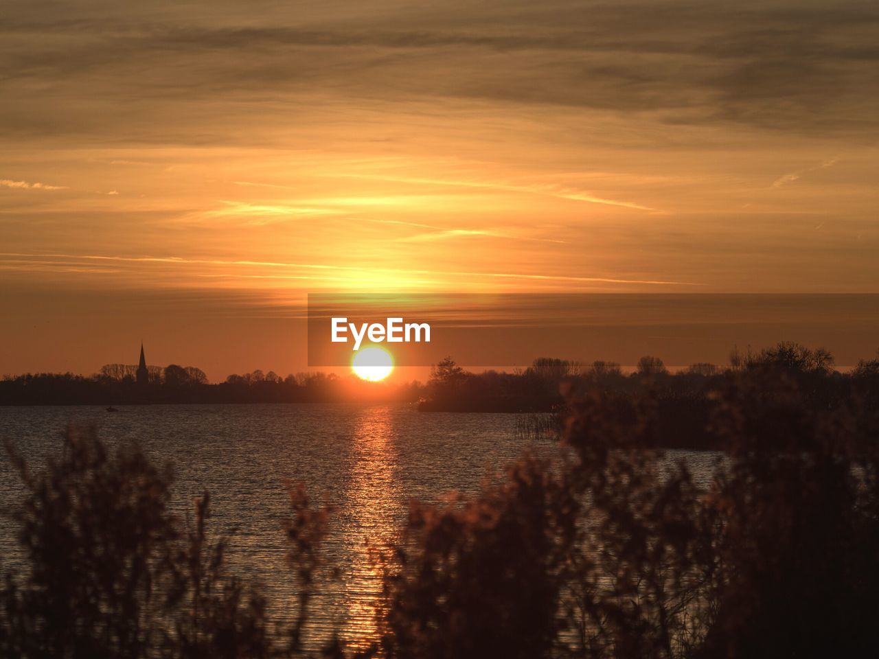 SCENIC VIEW OF LAKE AGAINST ORANGE SKY DURING SUNSET