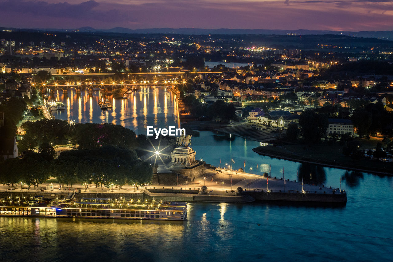 High angle view of river in illuminated city at night