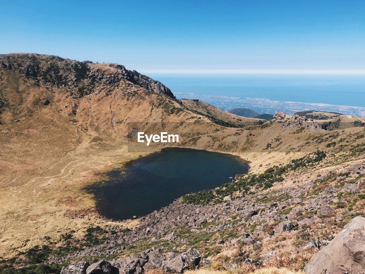 High angle view of land against blue sky