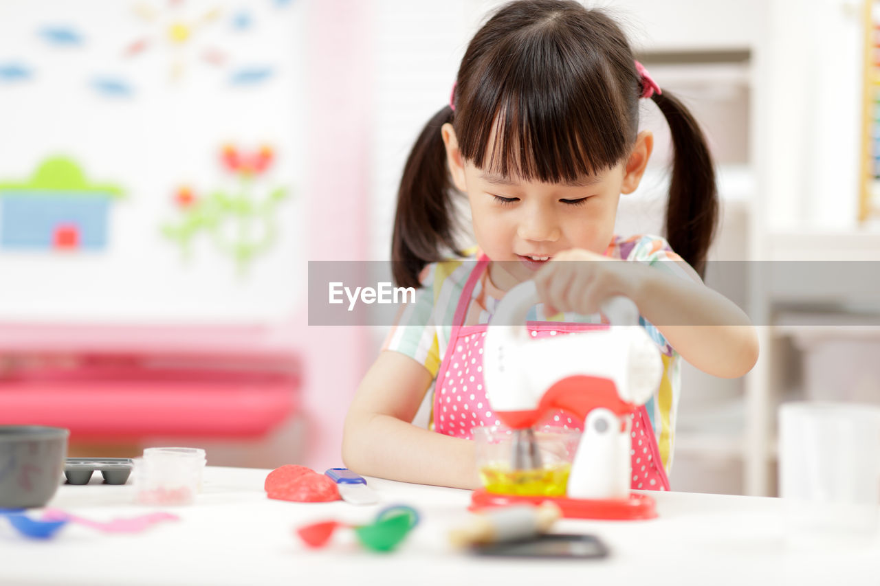 Portrait of a girl looking at table