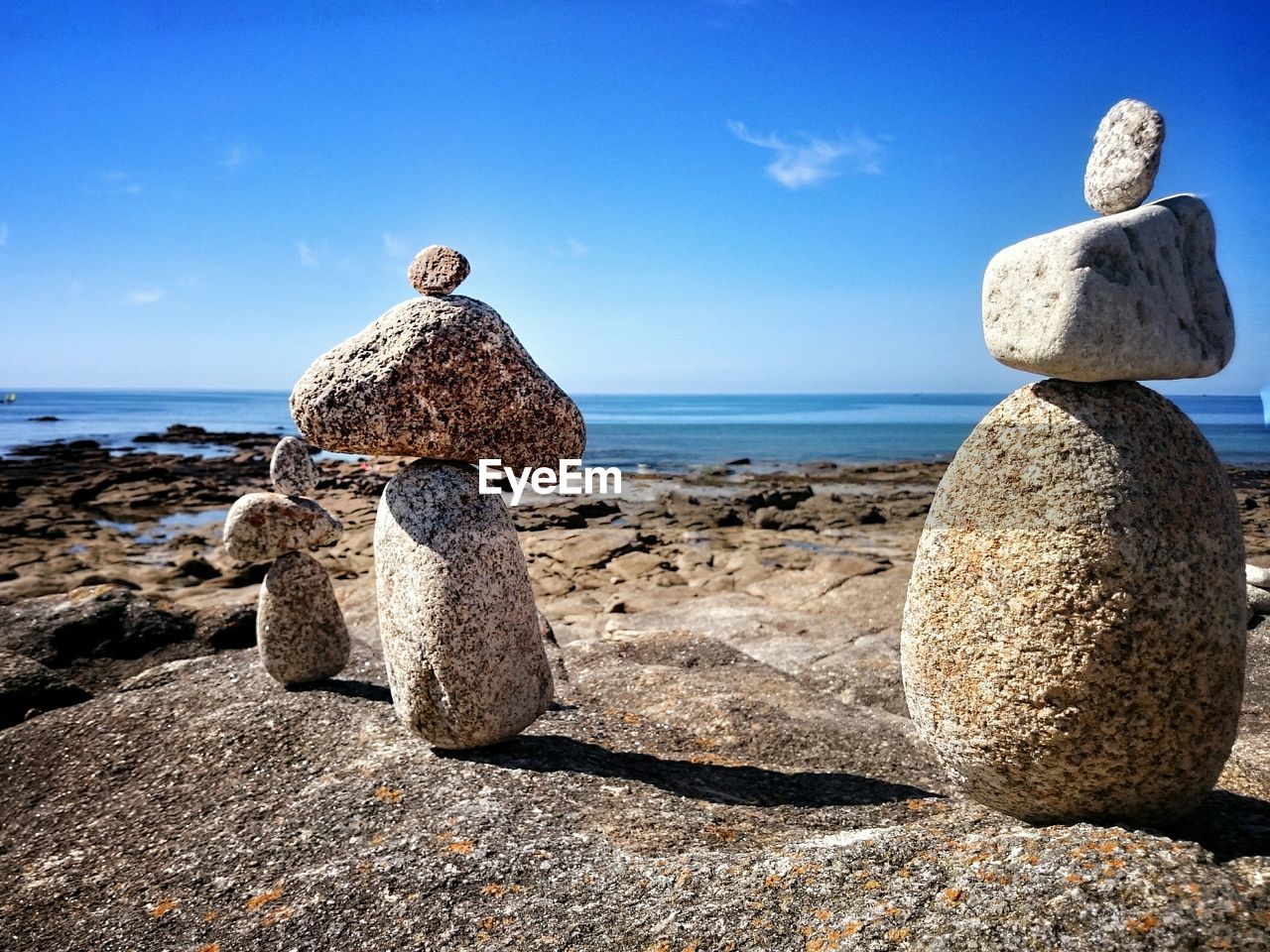 Stack of rocks on beach against sky