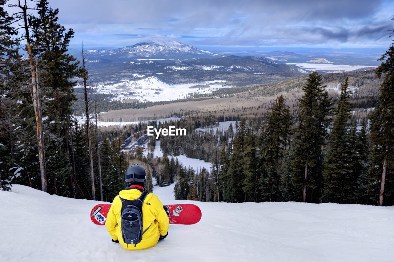 REAR VIEW OF WOMAN IN SNOW