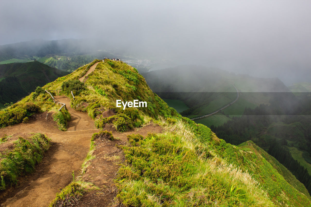 Scenic view of green landscape against sky