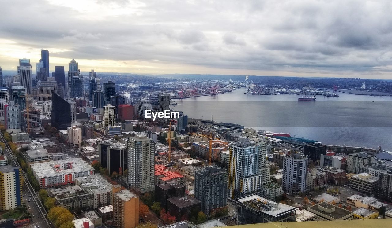 High angle view of cityscape against cloudy sky