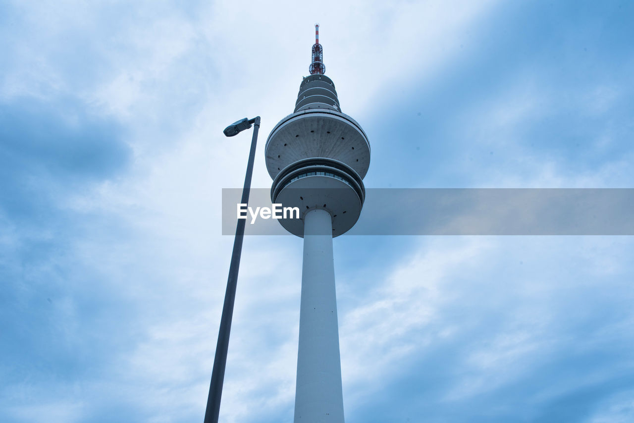 Low angle view of communications tower against sky