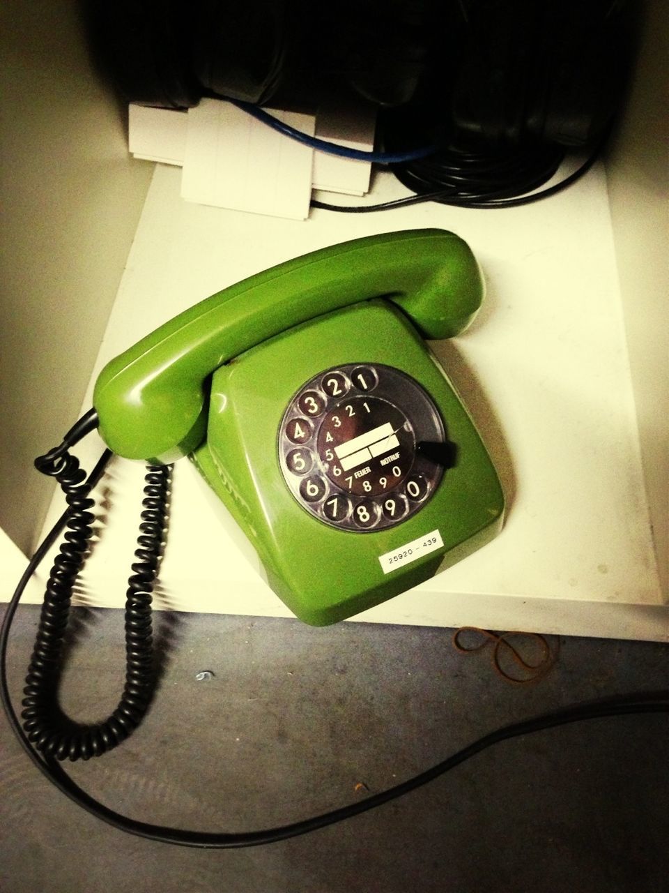 Close-up of green retro telephone on table