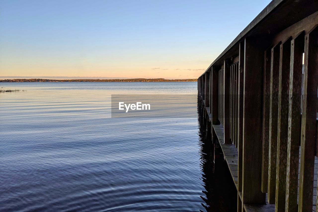 Scenic view of sea against clear sky during sunset