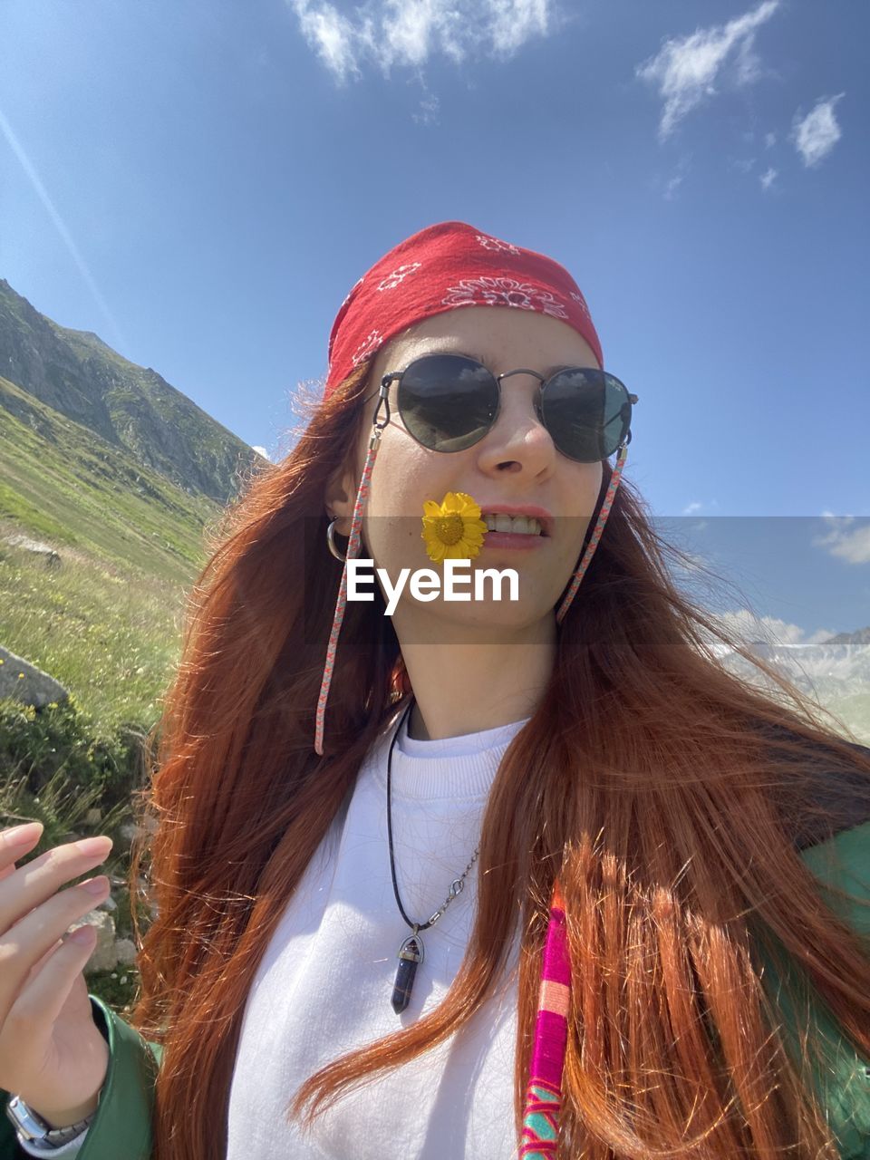 Portrait of young woman wearing sunglasses against sky