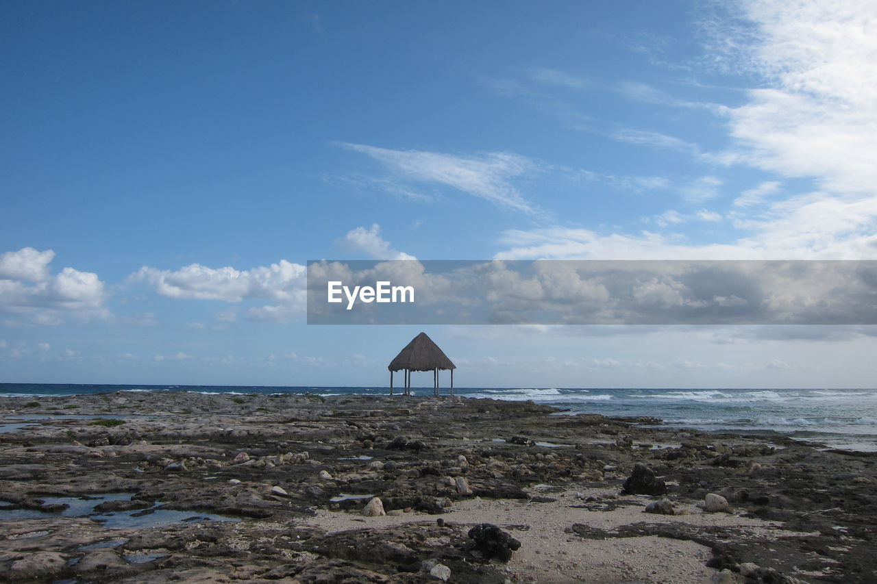 Scenic view of sea against cloudy sky