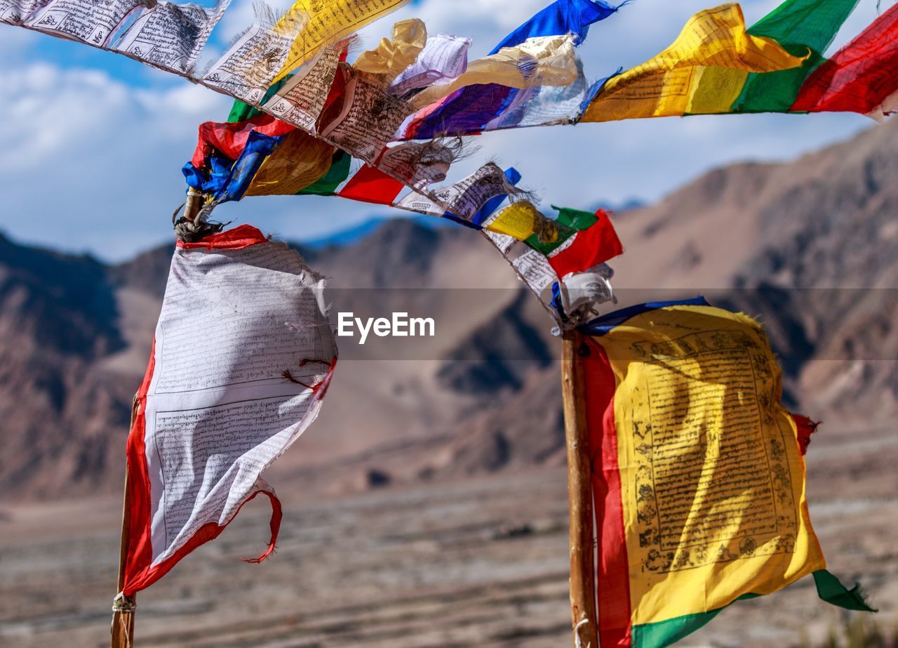 Close-up of multi colored flags hanging