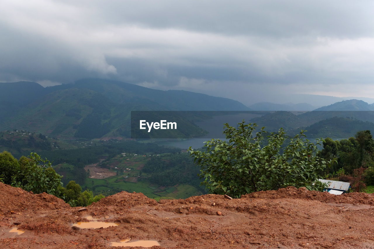 SCENIC VIEW OF TREES AND MOUNTAINS AGAINST SKY