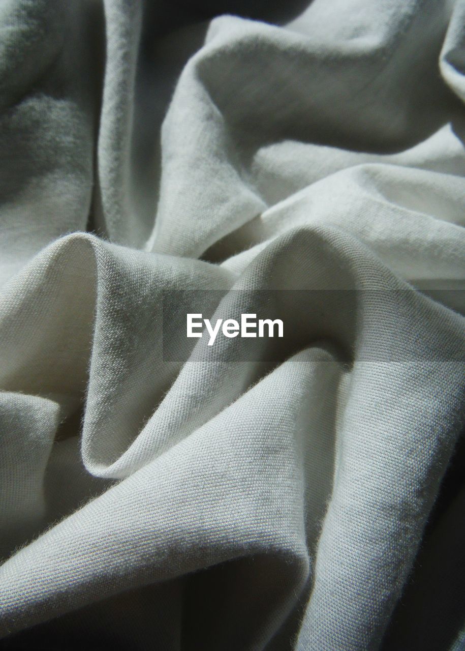 Close-up of crumpled blanket on bed