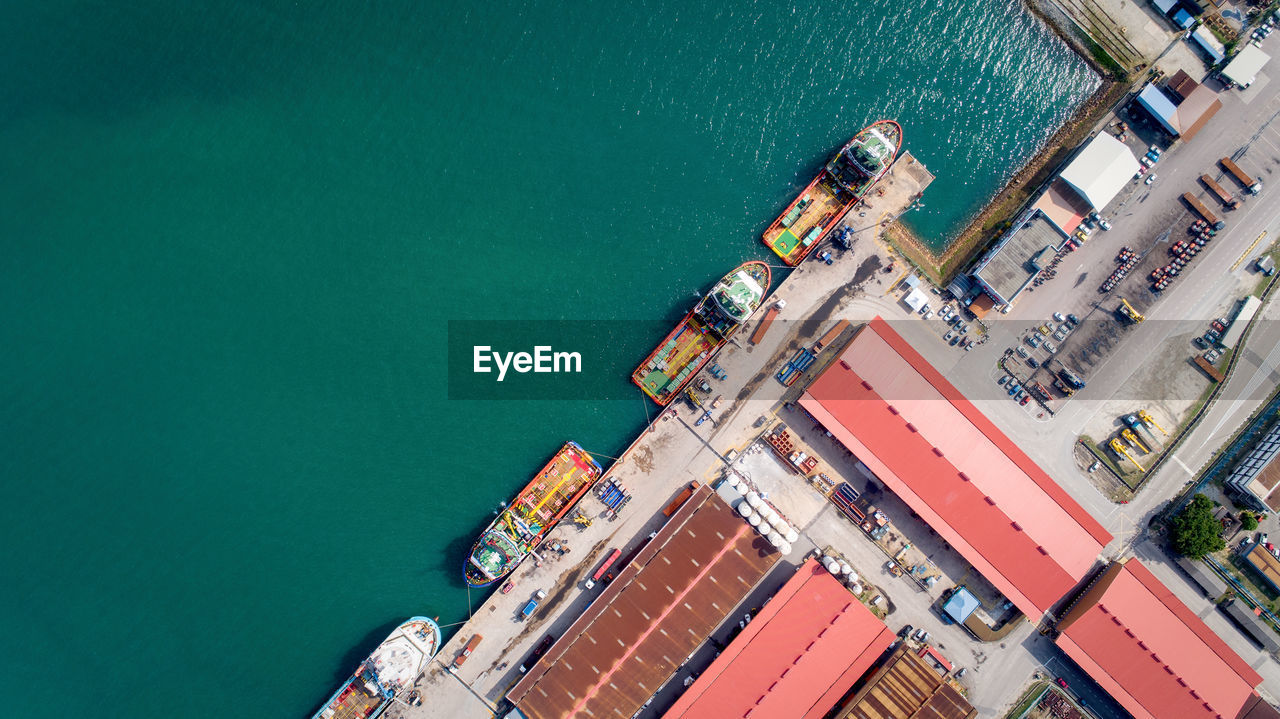 HIGH ANGLE VIEW OF HARBOR BY PIER ON SEA