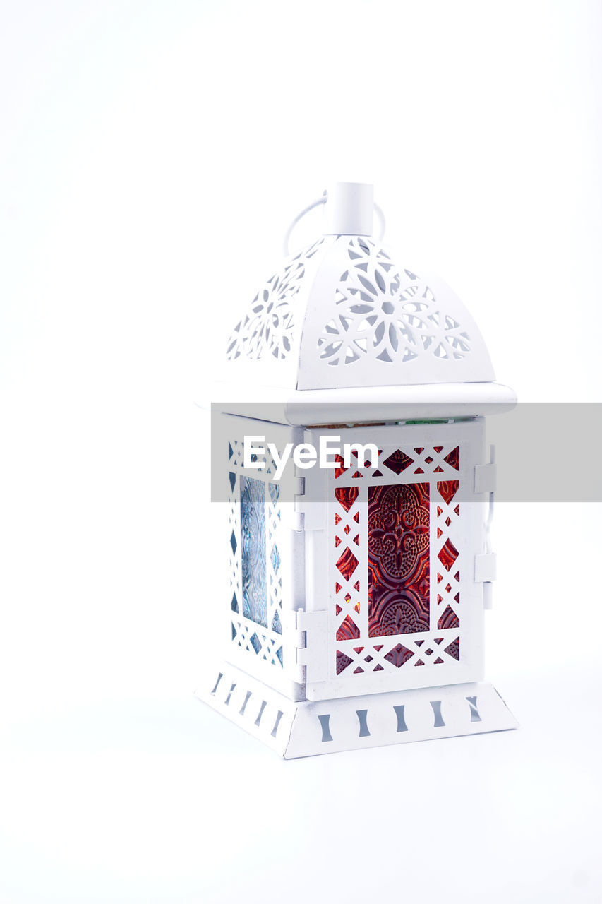 Close-up of lantern against white background