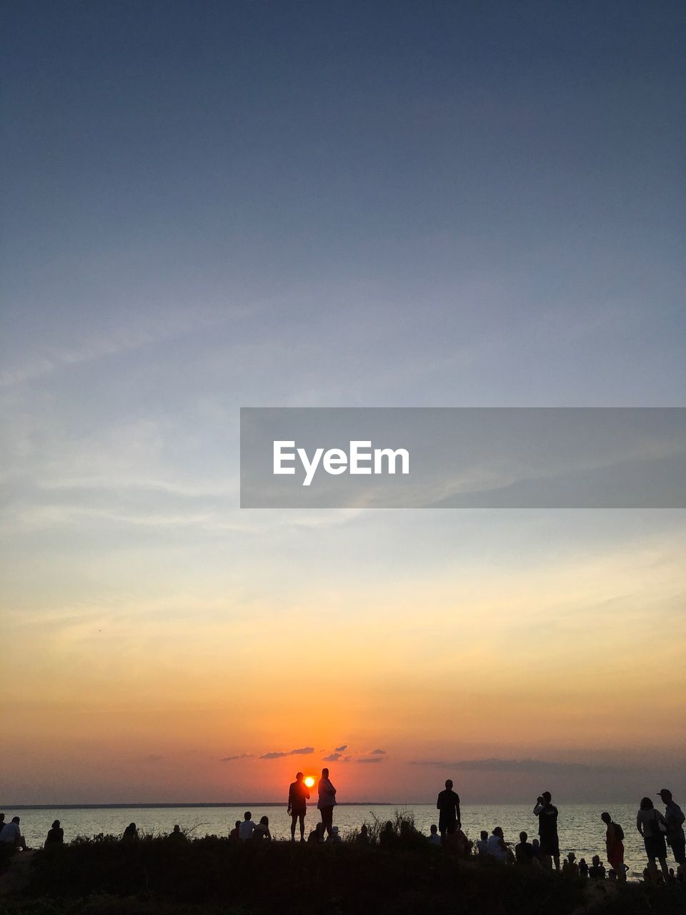 SILHOUETTE PEOPLE ON BEACH DURING SUNSET