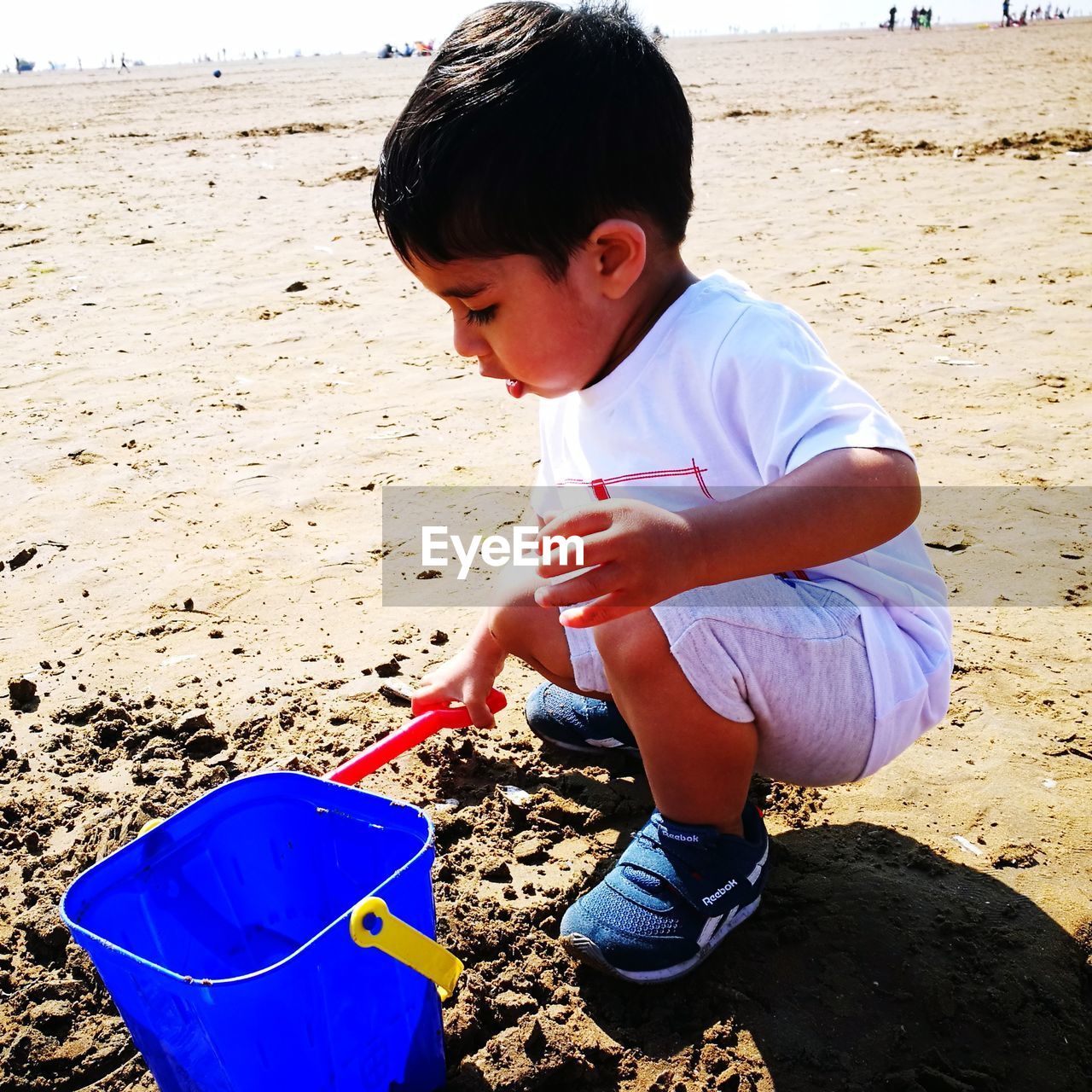 Boy playing with toy at beach