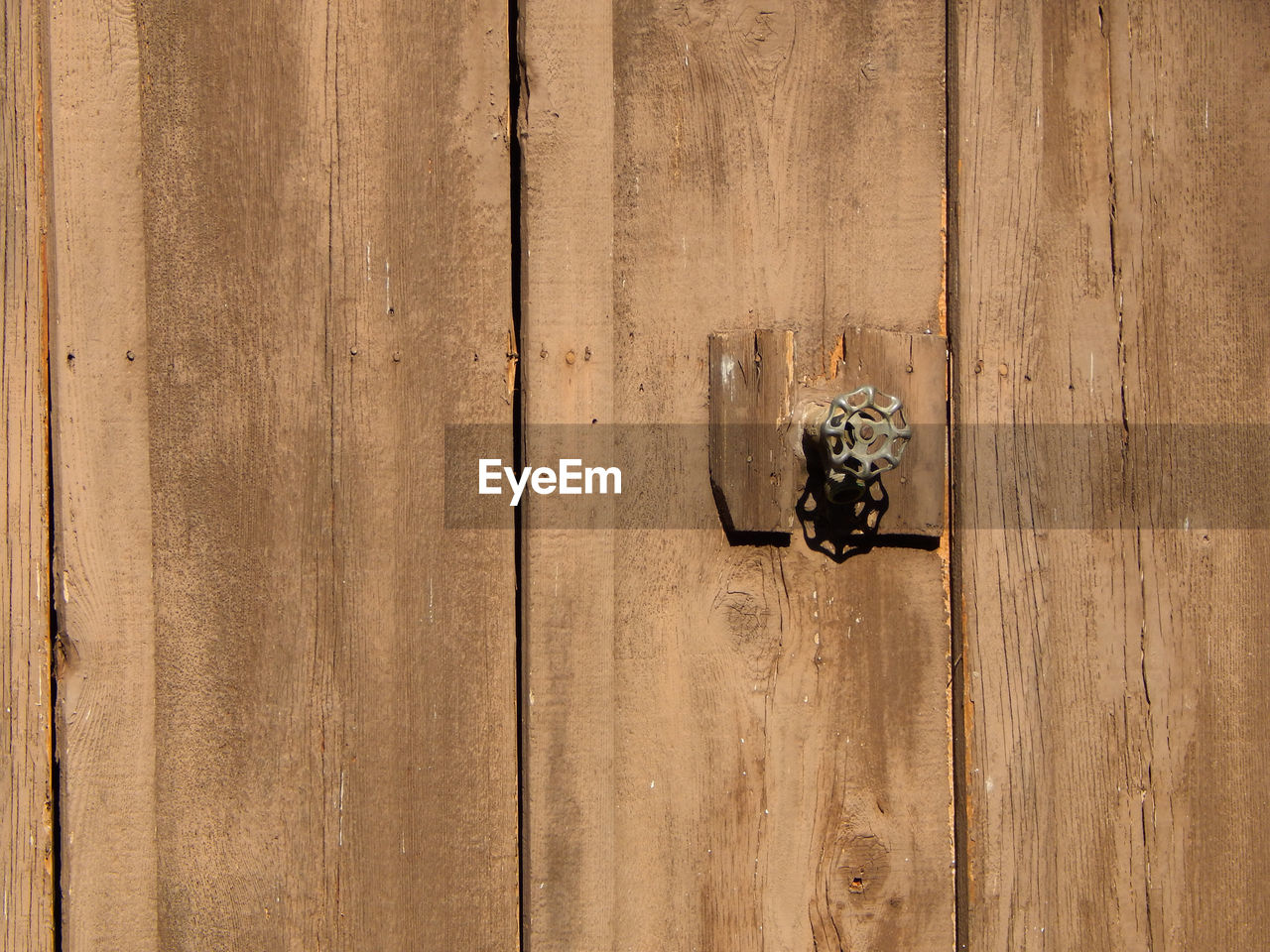 Close-up of wooden door with metallic knob