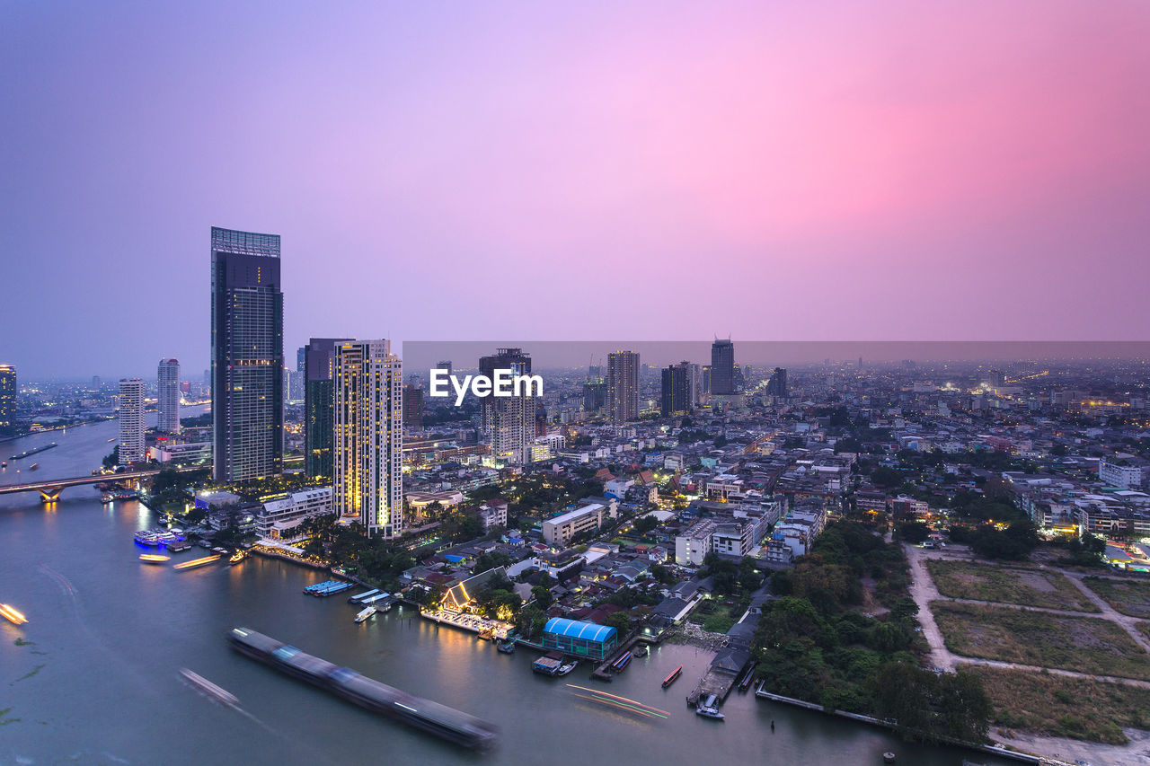 High angle view of illuminated buildings in city against sky