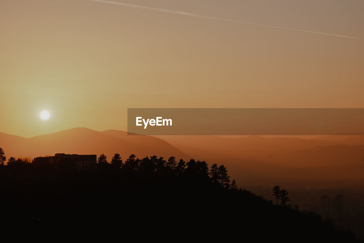 SILHOUETTE LANDSCAPE AGAINST SKY DURING SUNSET