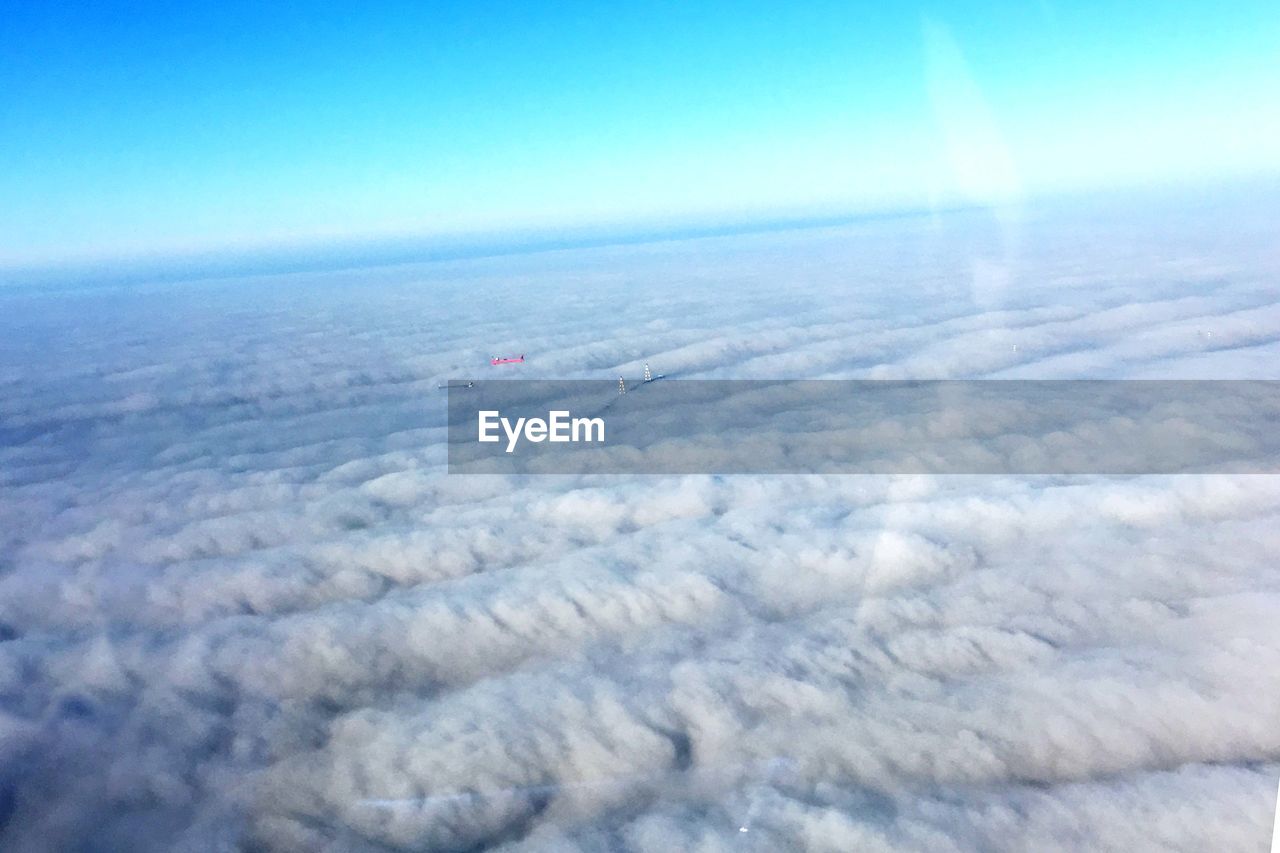 AERIAL VIEW OF SEA AGAINST BLUE SKY