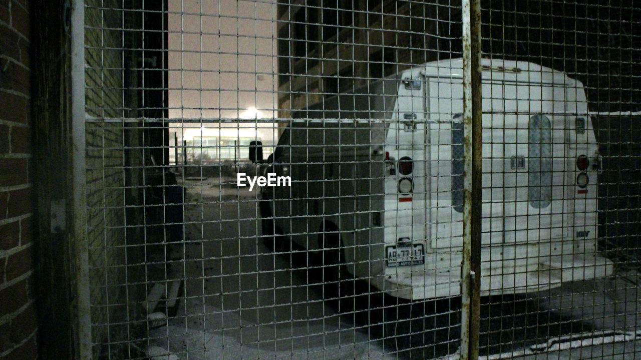 HIGH ANGLE VIEW OF CAT IN CAGE AT ZOO