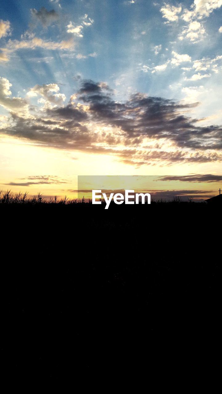 SILHOUETTE FIELD AGAINST SKY DURING SUNSET