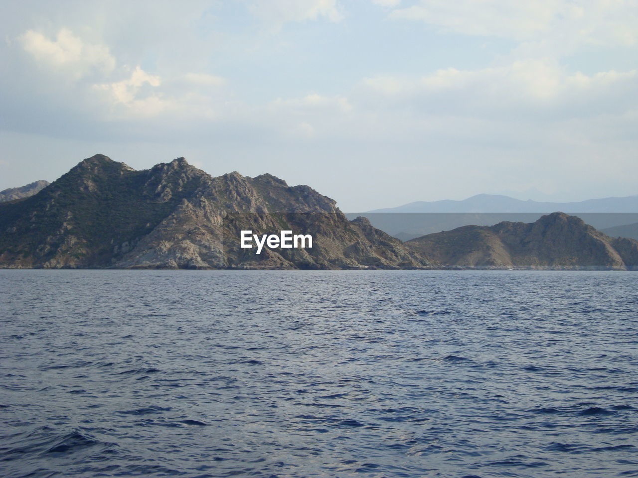 Scenic view of mountains against cloudy sky